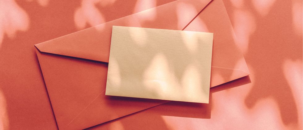envelopes stacked on orange background
